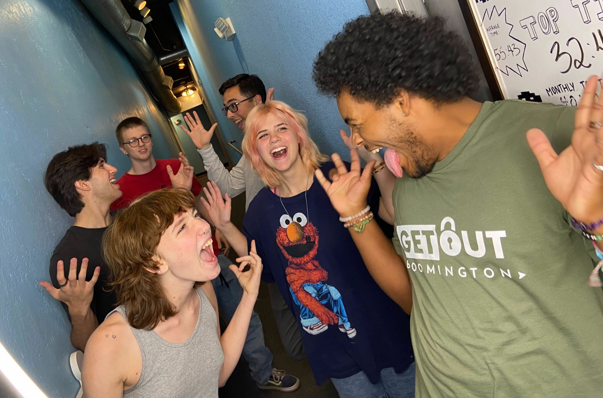 A group celebrating after escaping a room at Get Out: Bloomington